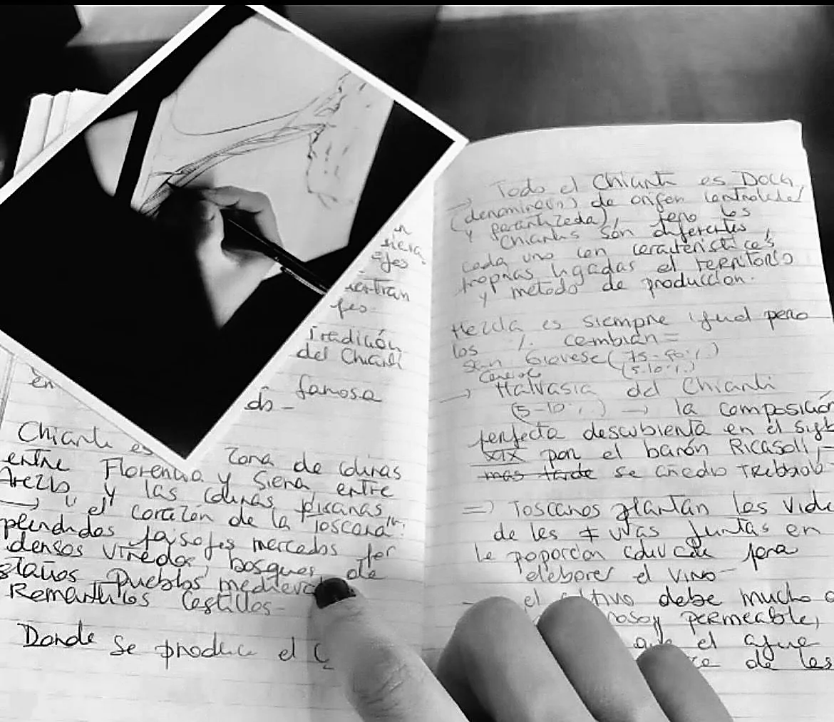 Handwritten travel journal and a black and white photograph on a table